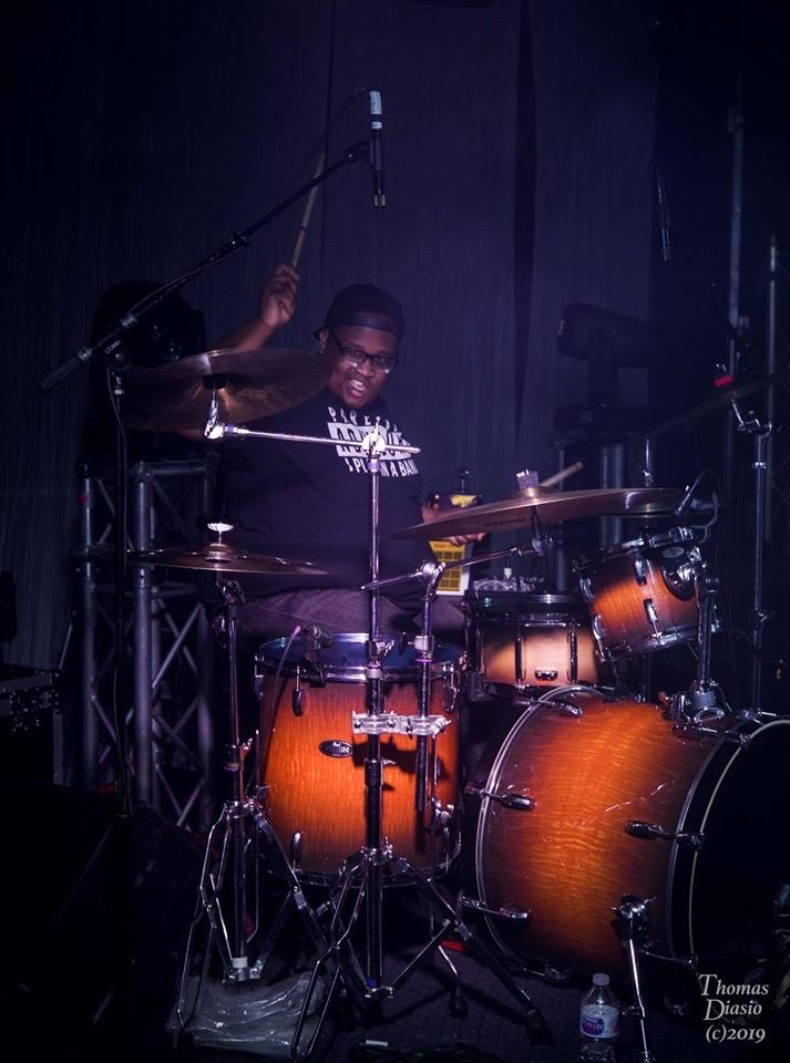 J Sledge on the drums, live performance